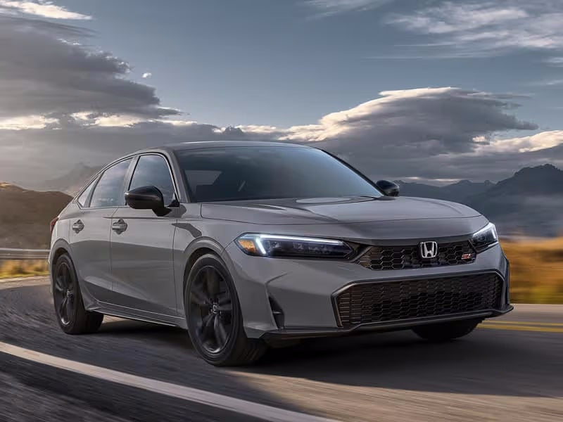 Gray Honda car driving on a road.