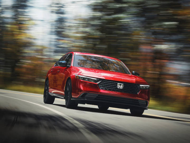 Red car driving on road.