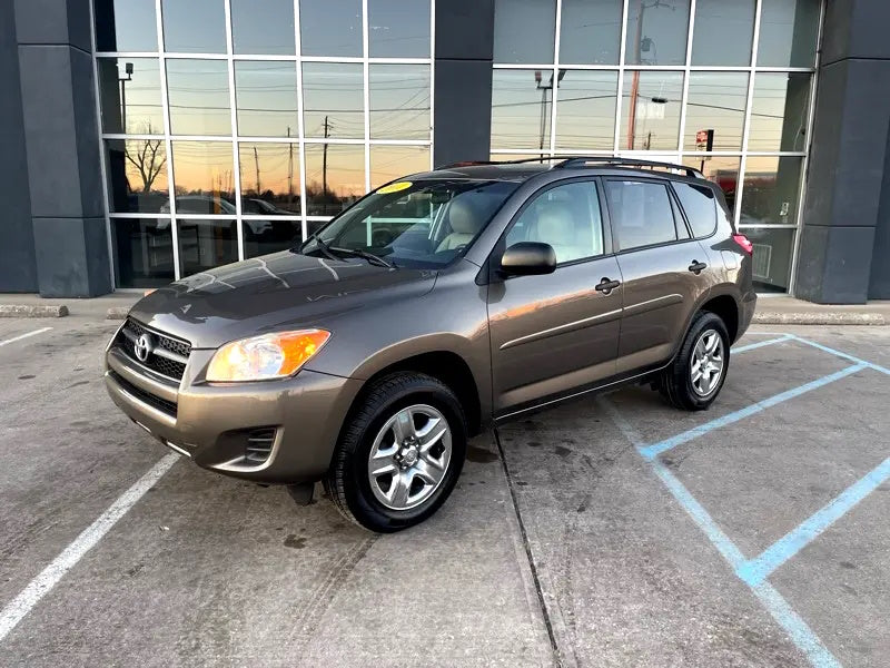 Brown SUV parked in front of a building.
