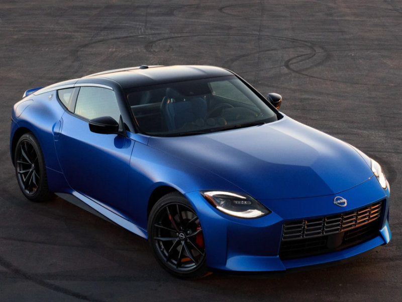 Blue sports car on asphalt.