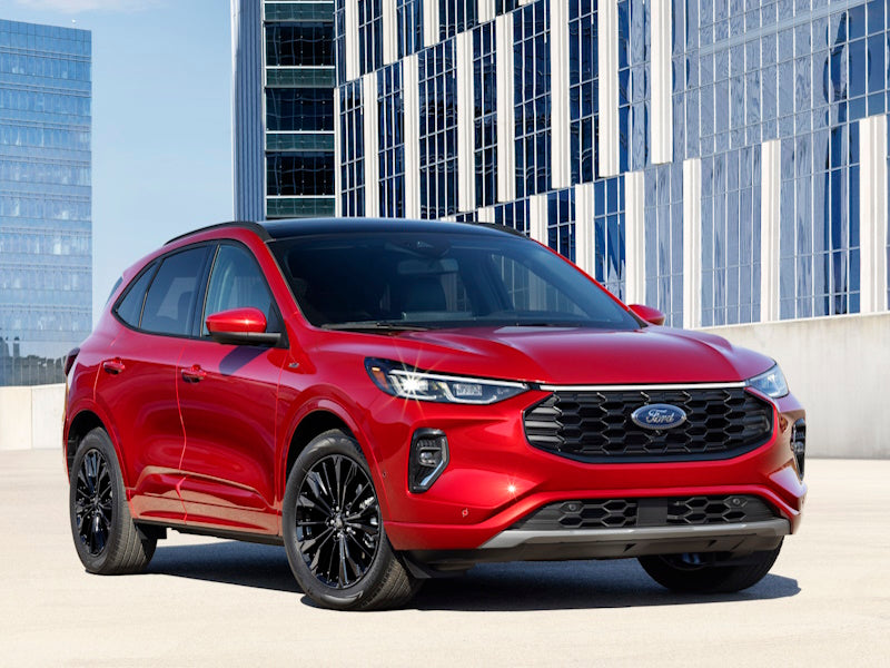 Red Ford SUV parked in front of a building.