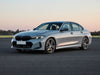 Silver BMW sedan on asphalt.