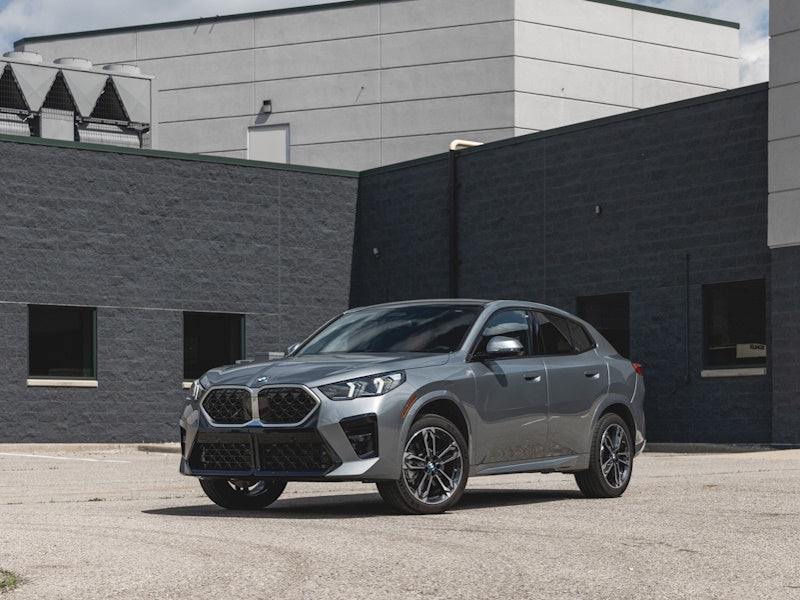 Gray SUV parked in front of a modern building.