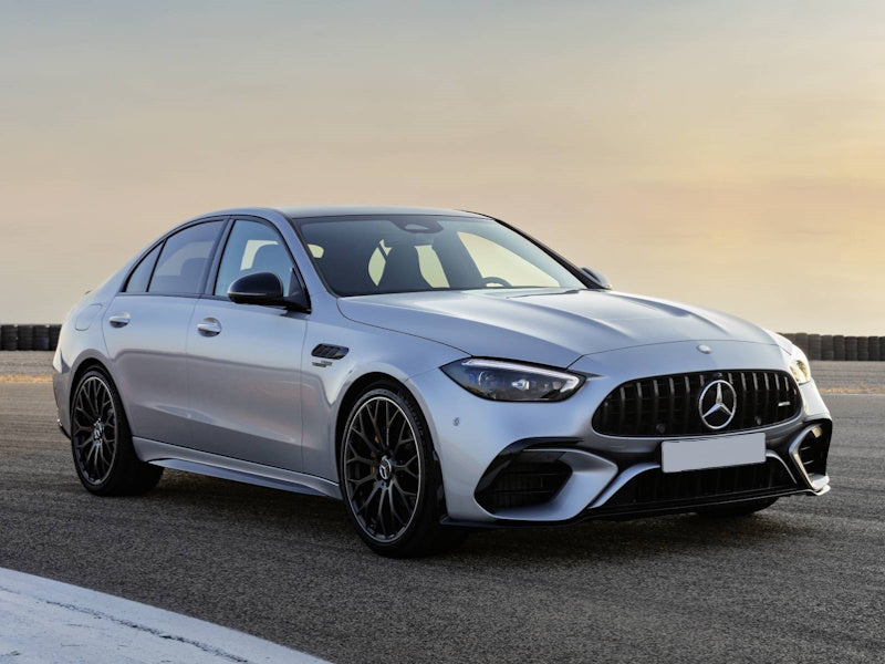 Silver Mercedes-Benz sedan on a road.