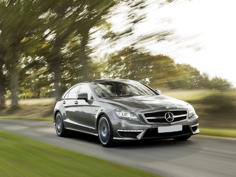 Gray Mercedes-Benz car driving on a road.