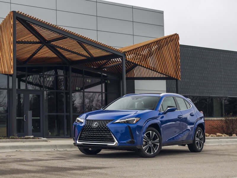 Blue SUV parked in front of a building.