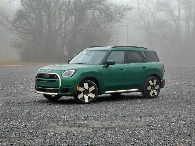 Green Mini Cooper SUV parked outdoors.