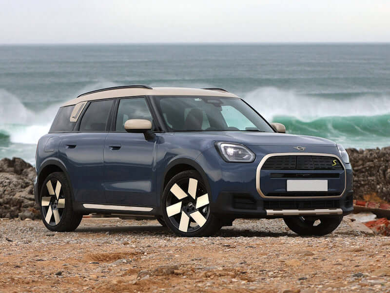 Blue SUV parked on a beach with ocean waves in the background.