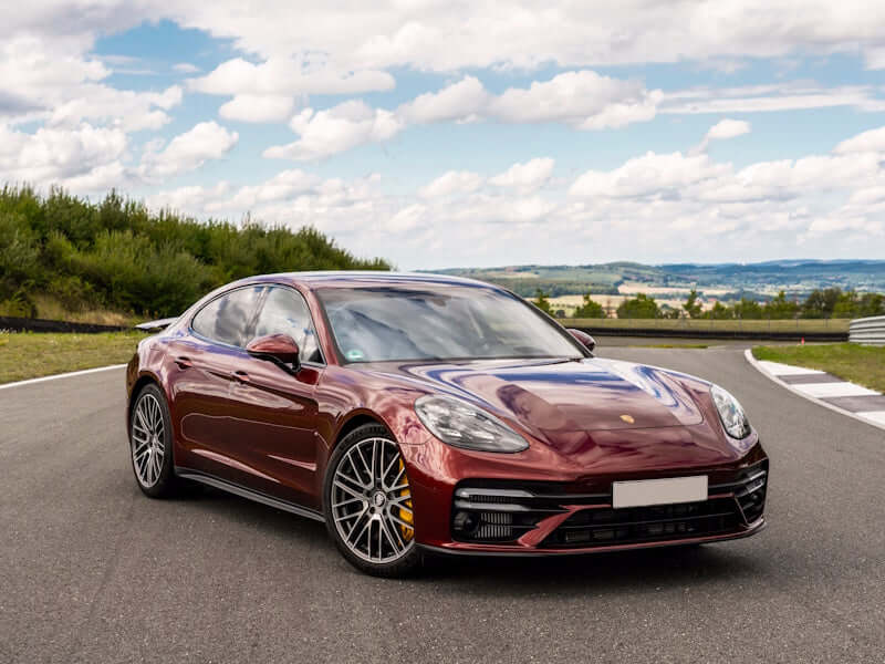 Red sports car on a racetrack.