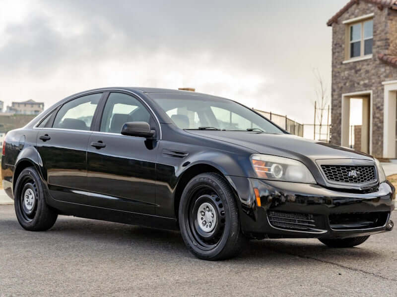 Black sedan parked in front of a building.