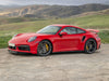 Red 2013-2020 Porsche 911 GT3 parked on dirt road with green hills in...